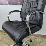 Stylish rotating leather mid-back office chair offering ergonomic support and a sleek design for any workspace.